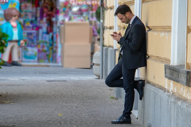 Włoski mężczyzna w garniturze, opierający się o ścianę